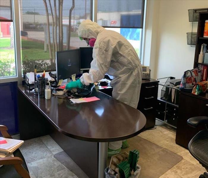 Team member in PPE in an office.