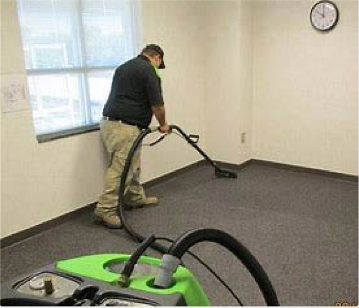 Team member extracting water in office.